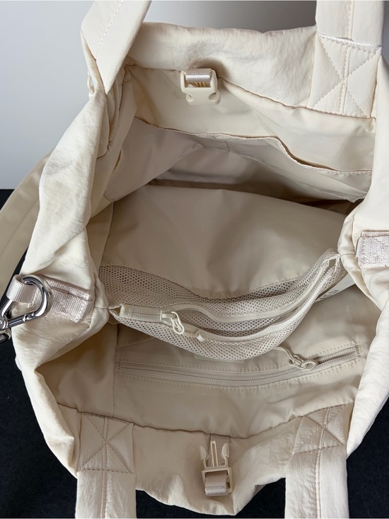 a leather travel duffel or bag Duffle Black category_hierarchy:girl Osprey Packs Aoede 7L Roosevelt leaned against the color:mahogany/iris